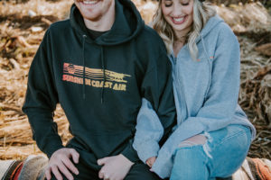 Couple in Sunshine Coast Air hoodies